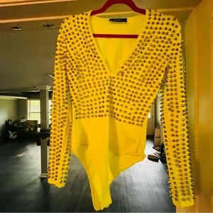 AKIRA, neon yellow, long sleeve, body suit, with silver studs covering the top
